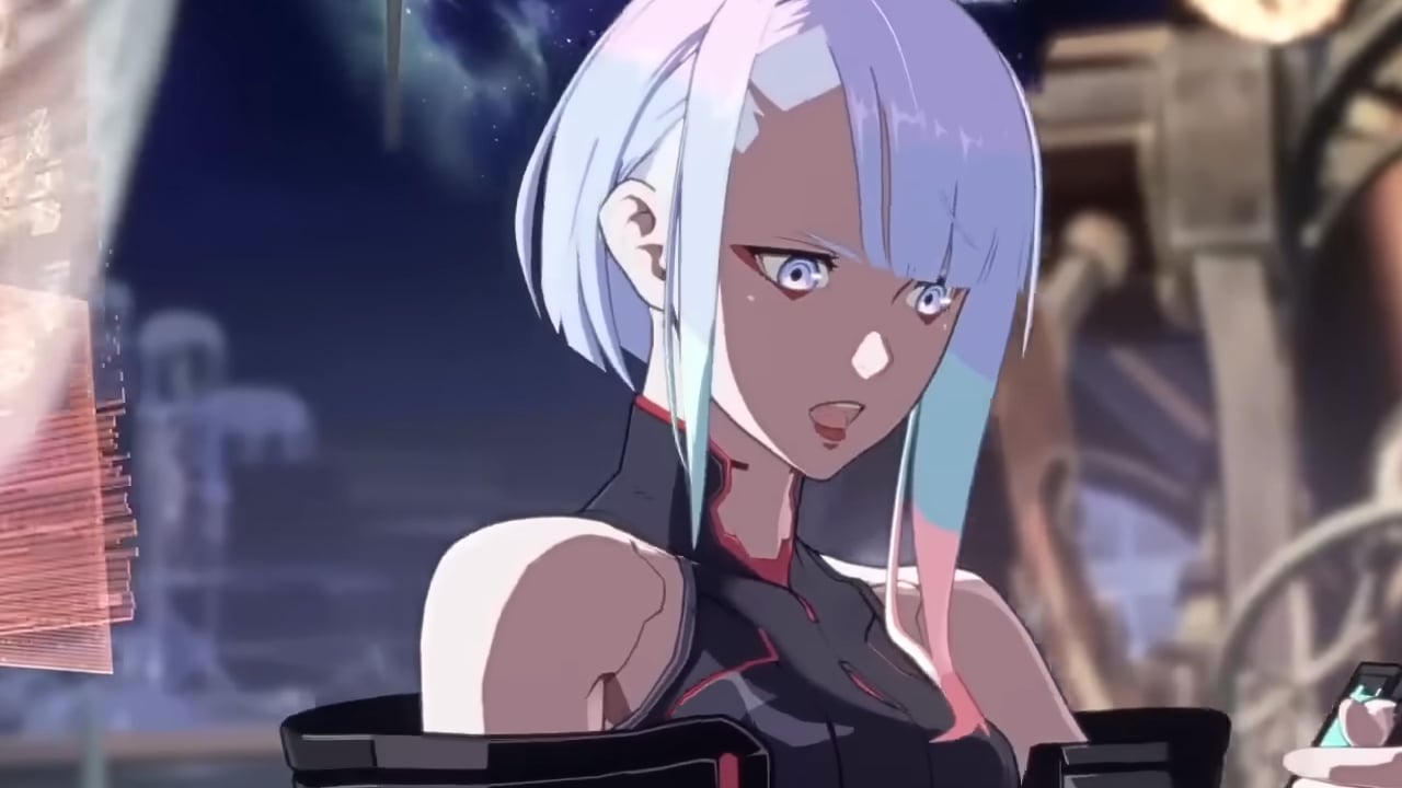 Lucy looks at a device in her hands