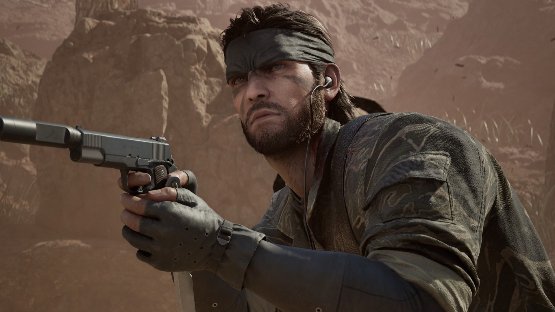 Snake looks up while holding a silenced pistol.